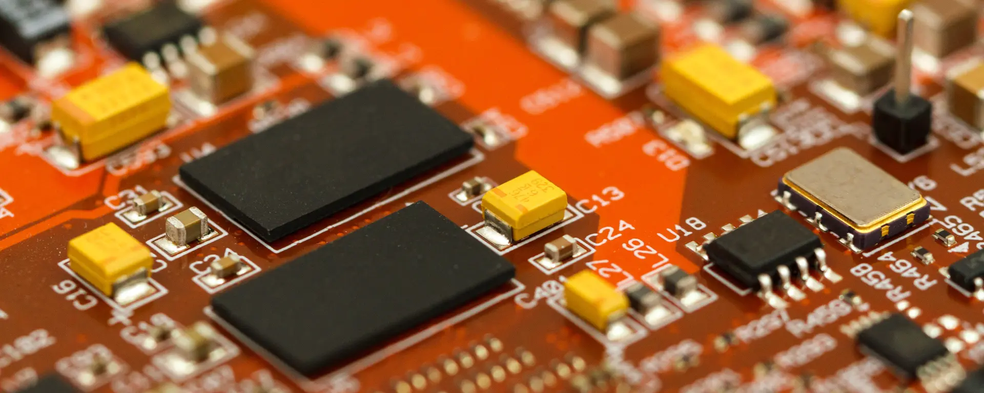 Close-up of a dark electronic circuit board with processors and components