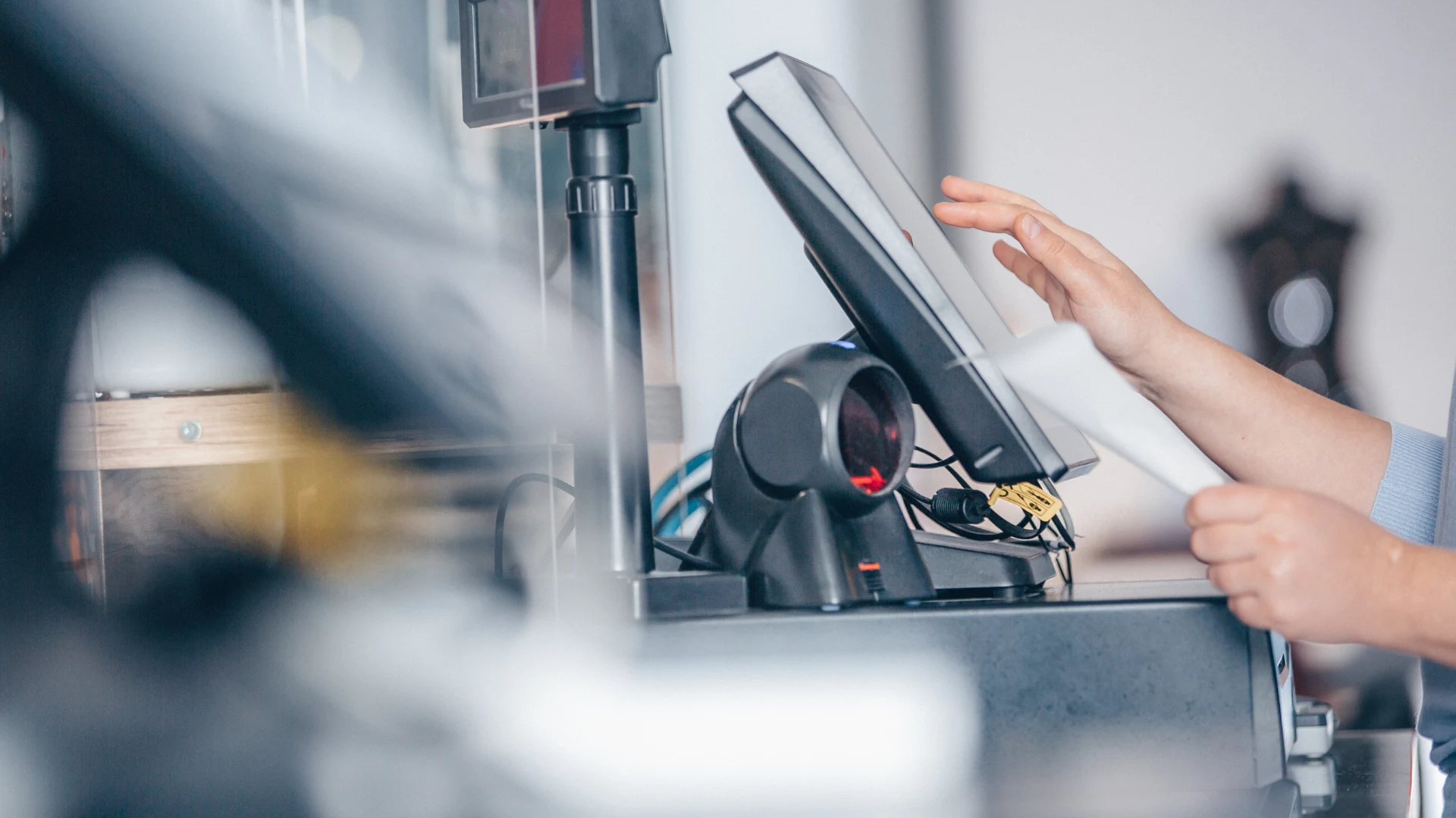 Retail staff completing a point-of-sale transaction with a customer